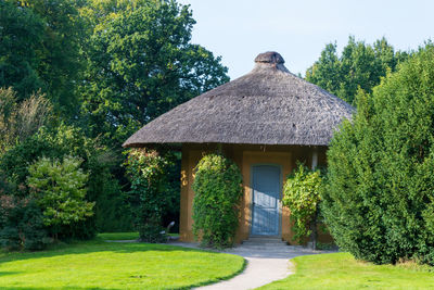 House amidst trees and plants in garden