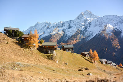 Scenic view of snowcapped mountains against clear sky