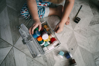 High angle view of child with watercolors