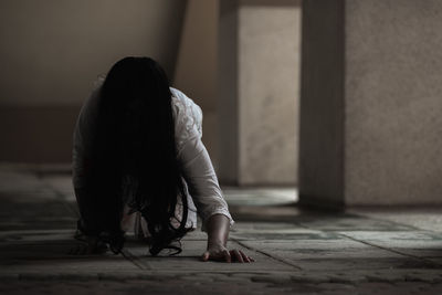 Woman sitting on floor