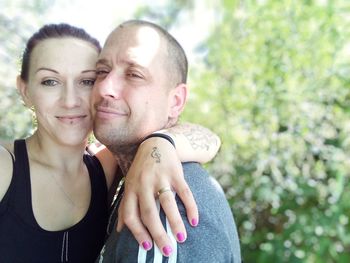 Portrait of young couple kissing outdoors