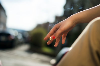 Midsection of woman hand on cross