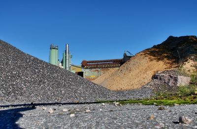 View of construction site against clear blue sky