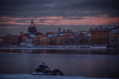 View of cityscape against cloudy sky