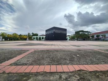 Road by building against sky