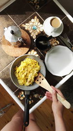 High angle view of person cooking mashed potatoes in kitchen