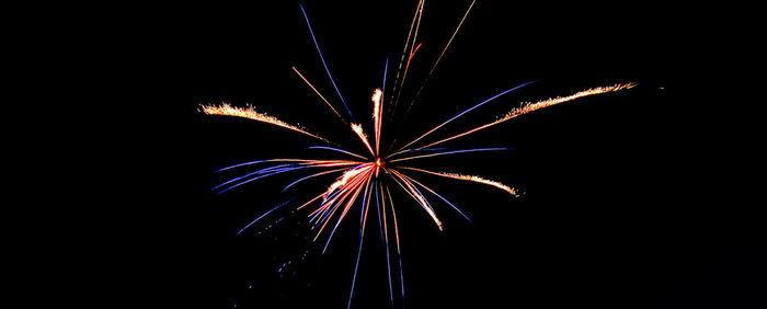 Low angle view of firework display at night