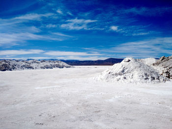 Scenic view of mountain range against cloudy sky