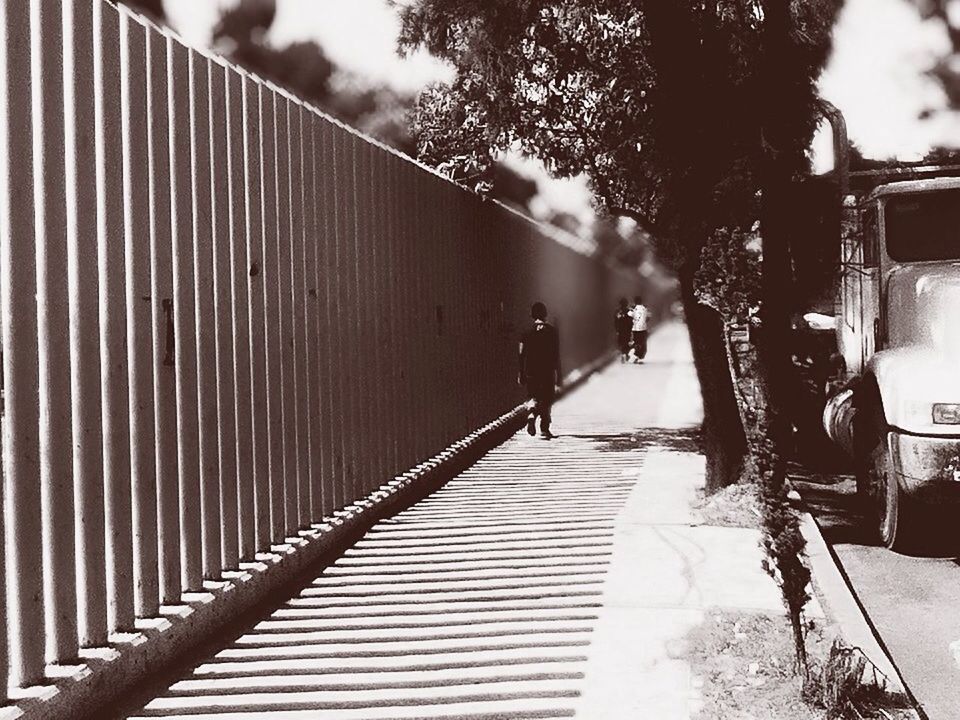 the way forward, built structure, architecture, building exterior, diminishing perspective, vanishing point, walking, tree, transportation, street, railing, rear view, sky, footpath, walkway, full length, day, outdoors