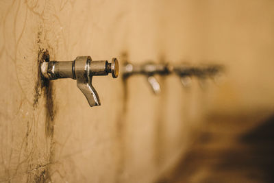 Close-up of water tap on wall