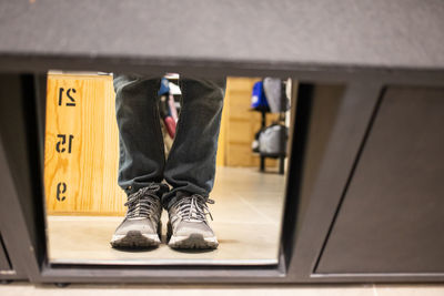 Low section of man standing on floor