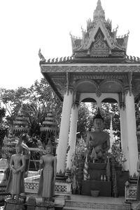 Low angle view of statue against temple against clear sky