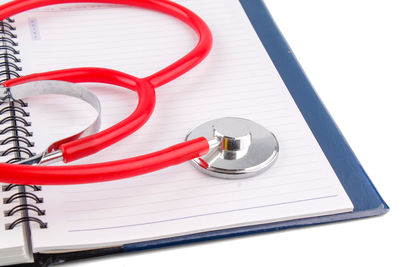 Close-up of stethoscope on spiral notebook