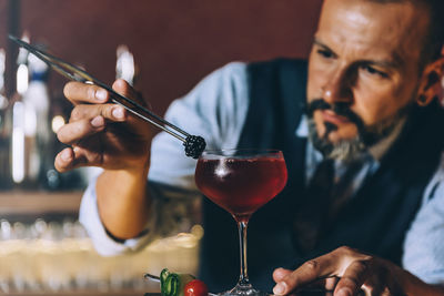 Bartender preparing cocktail in bar