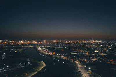 High angle view of illuminated city buildings at night