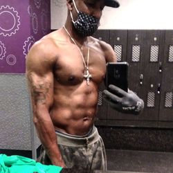 Midsection of shirtless man using mobile phone