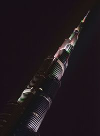 Low angle view of skyscraper at night