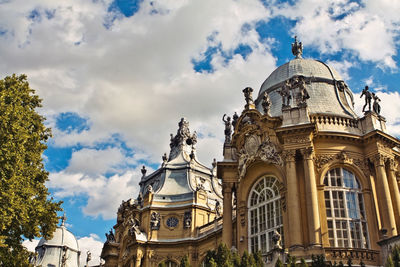 Low angle view of statues on building against sky