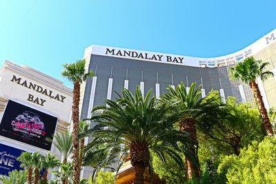 Low angle view of text on building against clear sky