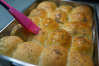 Close-up of poppy seed bun in tray