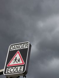 Low angle view of road sign against sky