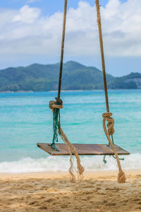 Rope on beach against sky