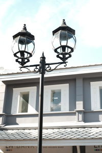 Low angle view of street light against building