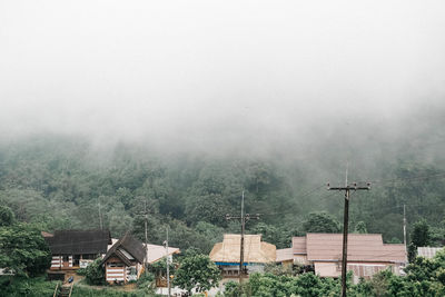 Buildings against sky during foggy weather