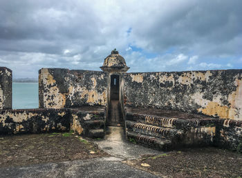 View of old building against cloudy sky