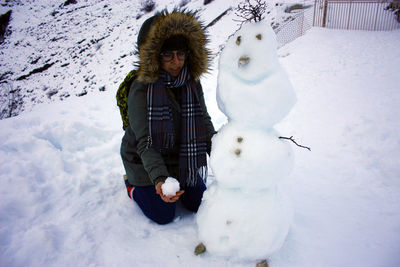 Portrait of man on snow covered field