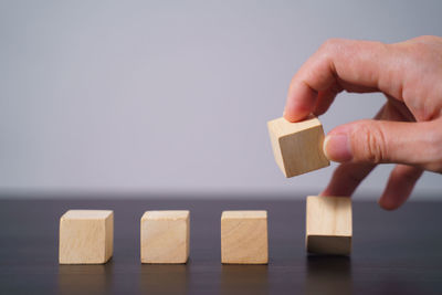 Close-up of hand holding toy on table