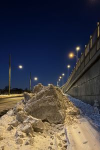 View of illuminated street against clear sky at night