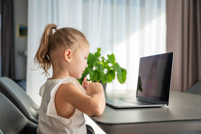 Young woman using laptop at home