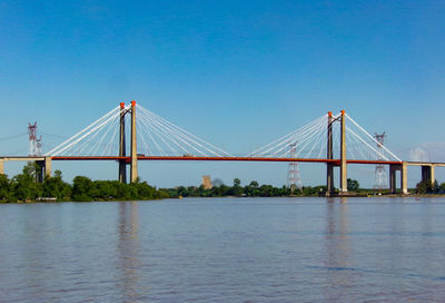 Bridge over river against clear blue sky in zarate