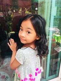 Portrait of smiling girl standing outdoors