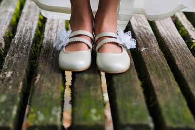 Low section of woman standing on wood