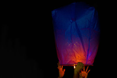 Close-up of illuminated lantern against black background