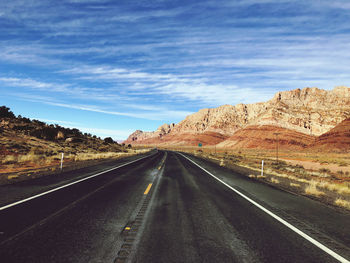 Empty road along countryside landscape