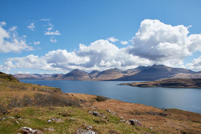 Scenic view of lake and mountains against sky