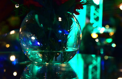 Close-up of illuminated glass with reflection