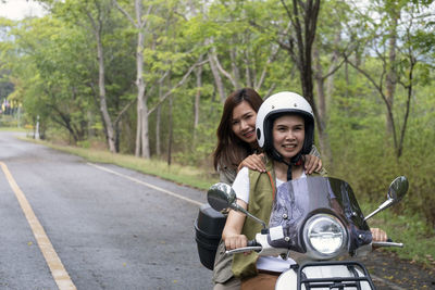 Same-sex couples happily drive together on a natural background.