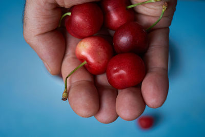 Close-up of hand holding strawberries