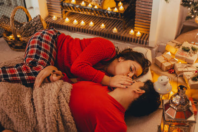 High angle view of couple kissing at home