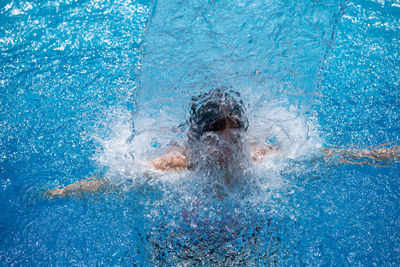 Man swimming in pool