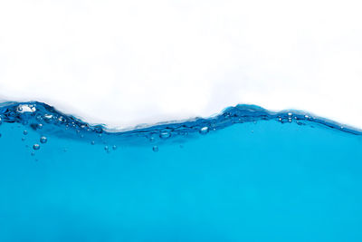 Close-up of water splashing against white background