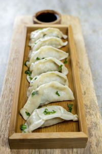 Gyoza or dumplings snack with soy sauce, selective focus, copy space.and chopsticks,side view.