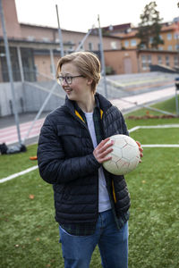 Teenage boy holding soccer ball