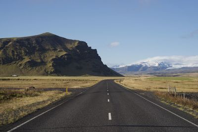 Lonely road leading towards the icelandic mountains 