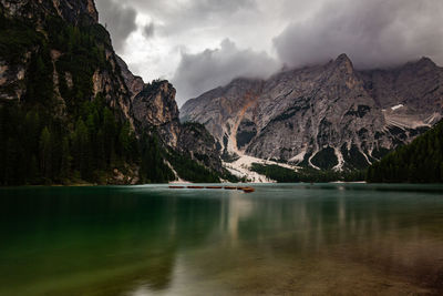 Scenic view of lake by mountains against sky