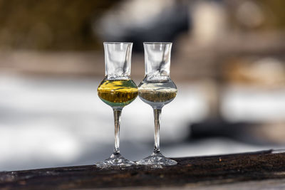 Close-up of wineglass on field